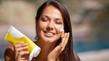 A portrait smile and a white woman with sunscreen on her face to protect her skin using SPF treatment concept, different SPF sunscreens