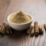 Ayurvedic ashwagandha and Liquorice root stick or jeshthamadh powder served in a bowl over moody background and impact of health benefits of ashwagandha