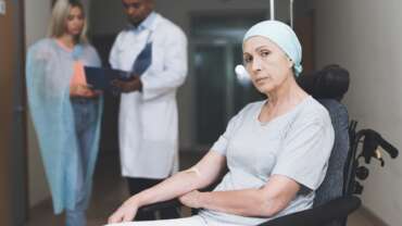 a woman with cancer and her daughter speaking with a doctor about food and cancer myths and treatment information