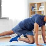 A man is doing running plank exercise at home following weekly recommended workout