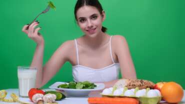anti-inflammatory diet concept where a woman eats vegetables for weight loss and detox diet healthy food