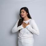 Portrait of an asian indian woman having a heart attack isolated on a white background. heart failure in women concept