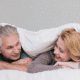 Happy couple over 40 embracing at home, representing healthy sex and intimacy after 40