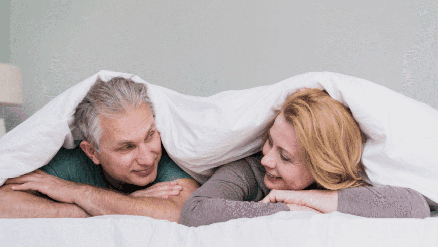 Happy couple over 40 embracing at home, representing healthy sex and intimacy after 40