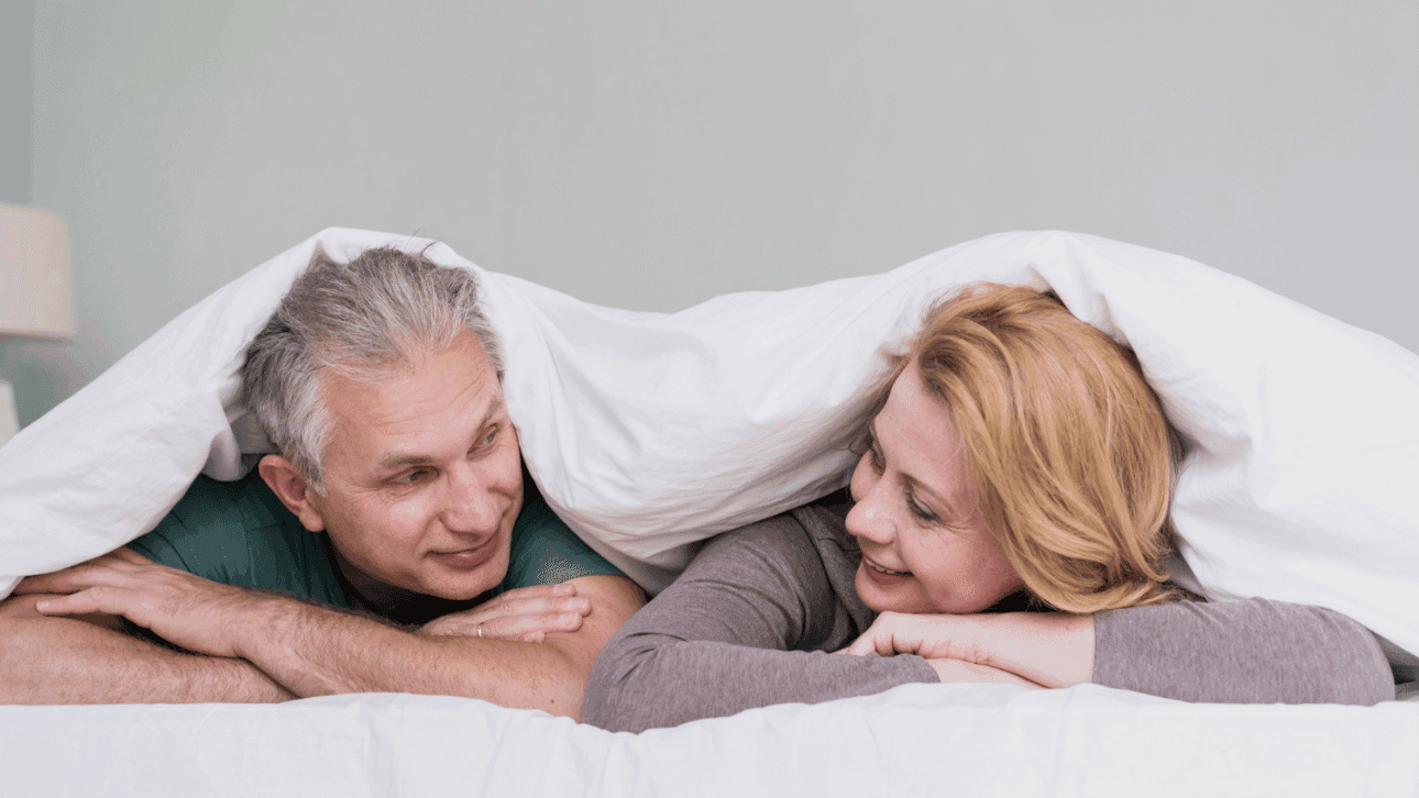 Happy couple over 40 embracing at home, representing healthy sex and intimacy after 40