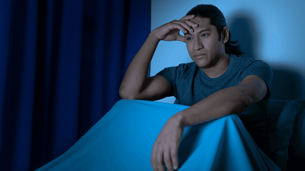 person awake at night clock dark room