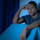 person awake at night clock dark room