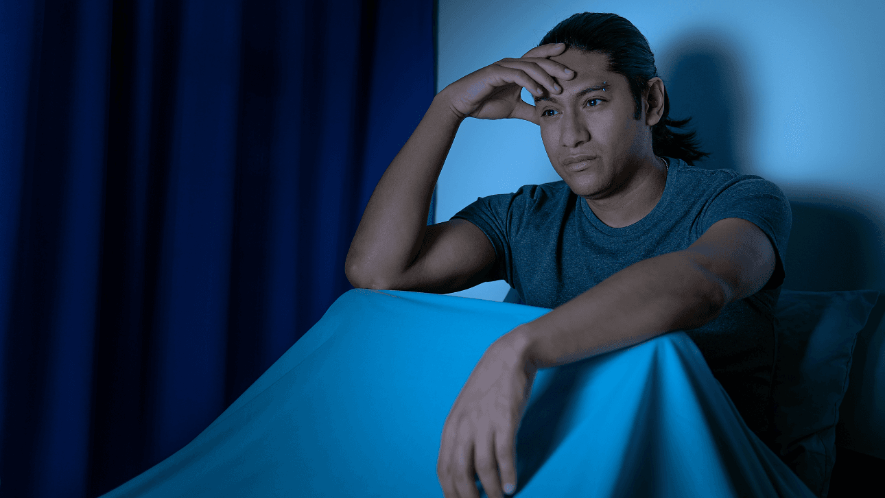 person awake at night clock dark room